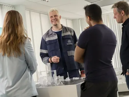 Matthias Eikelmann, visitor guide at thyssenkrupp Steel, giving a tour at the visitor center and explaining a model. Matthias Eikelmann, visitor guide at thyssenkrupp Steel, giving a tour at the visitor center and explaining a model.