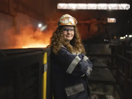 Pia Fork wearing safety gear including a helmet and protective glasses in an industrial setting at thyssenkrupp Steel. Pia Fork wearing safety gear including a helmet and protective glasses in an industrial setting at thyssenkrupp Steel.