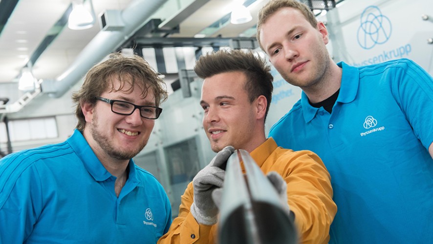 thyssenkrupp Steel employees inspecting a metal component together