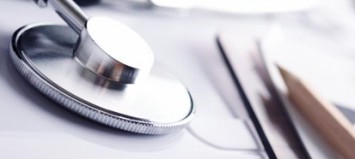 Stethoscope and office supplies on a white surface. Stethoscope and office supplies on a white surface.