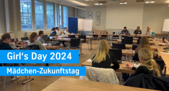 Female participants at Girl’s Day 2024 at thyssenkrupp Steel in an event space with group tables.